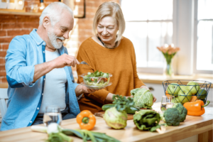An image of a senior couple choosing to eat a bowl of salad.