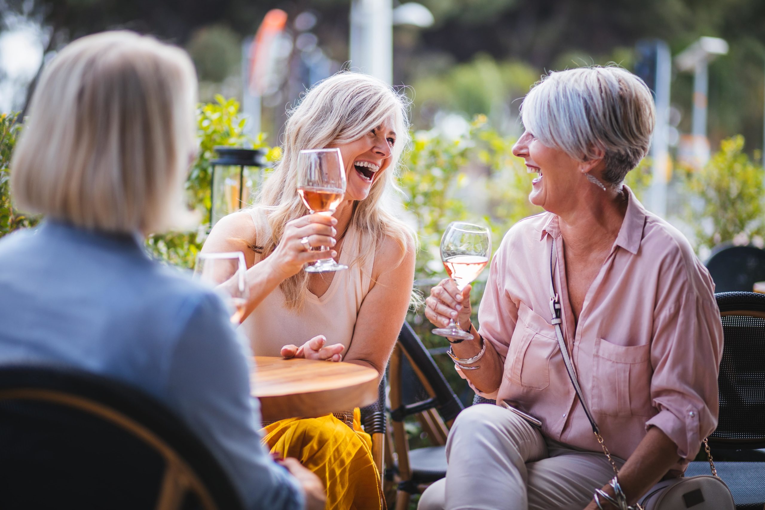 An image of two ladies drinking wine and enjoying each others company.