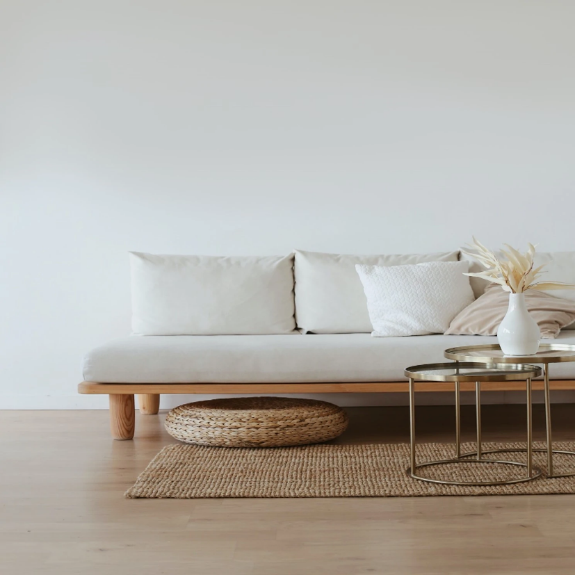 An image of a bamboo wood couch with white cushions.