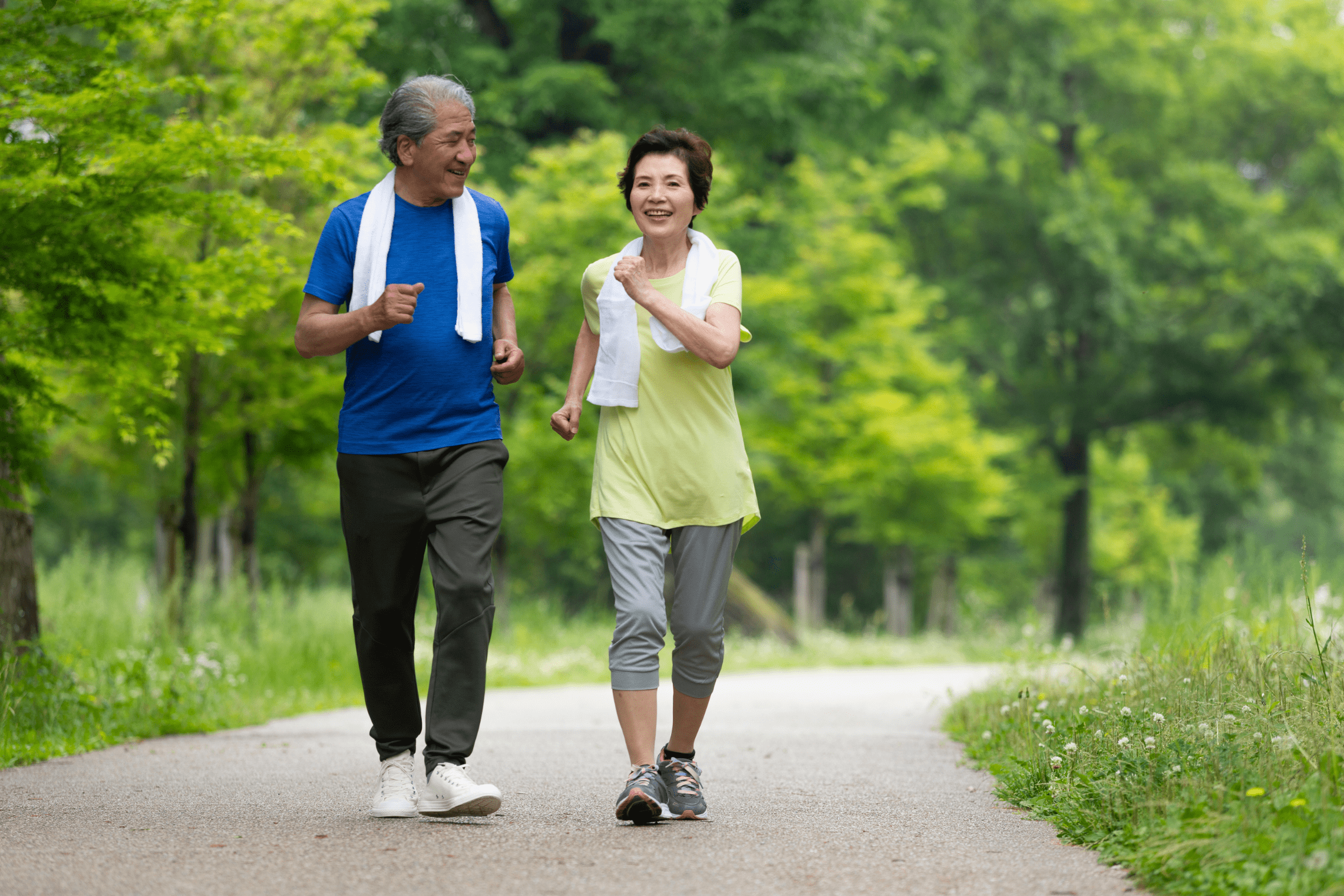 An image of an older man and woman going for a speed walk.