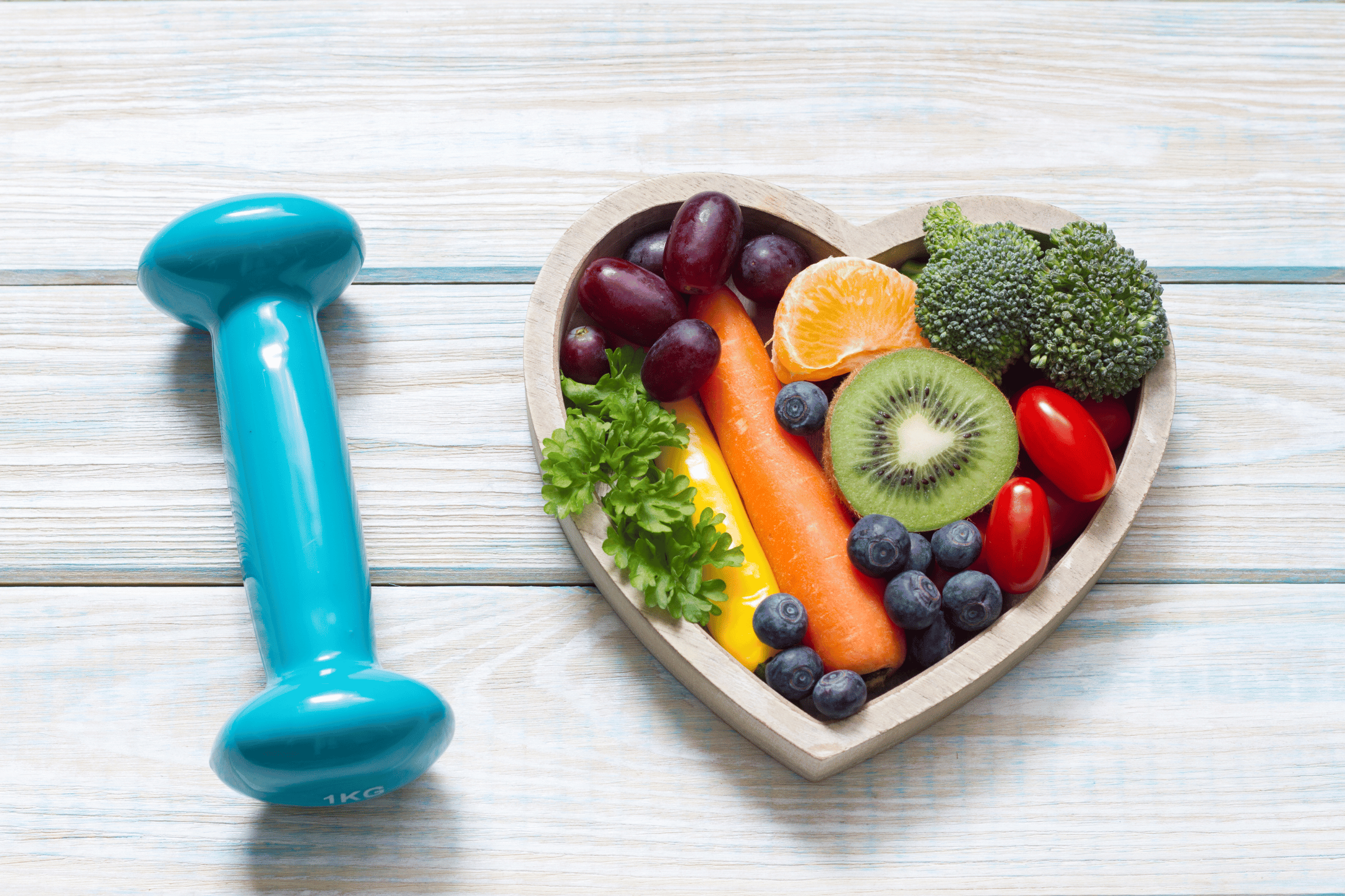 An image of veggies and an exercise barbell