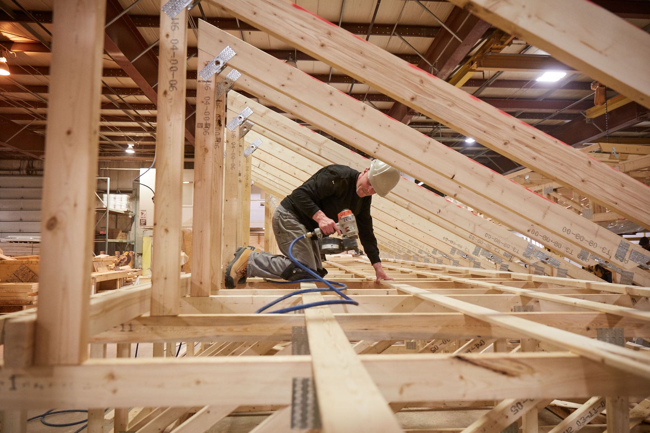 an image of a builder working in a house's rafters.