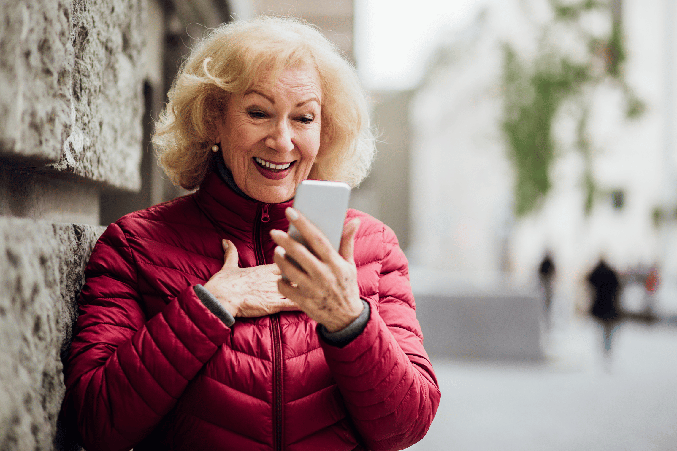An image of an older woman surprised at her phone
